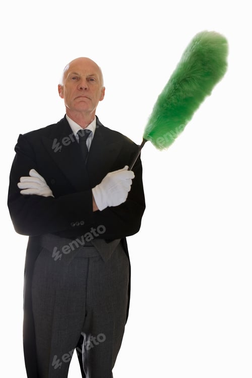 Preview: Cut Out Of Senior Male Butler Holding Feather Duster At Camera