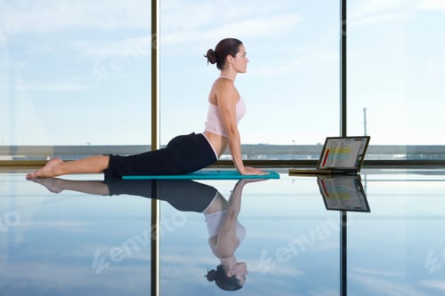 Preview: Woman Doing Yoga Whilst Working On Laptop