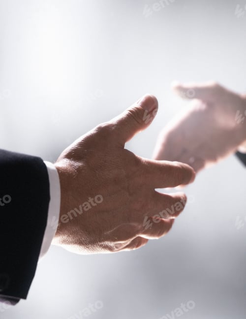 Preview: Close Up Of Businessman Shaking Hands To Close Deal Together