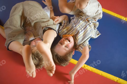 Preview: High Angle View Of Two Boys Playing On An Inflatable Bouncy Castle