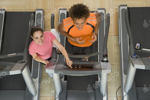 Preview: Fitness Instructor Training Man On Treadmill In Gym, Portrait, Elevated View