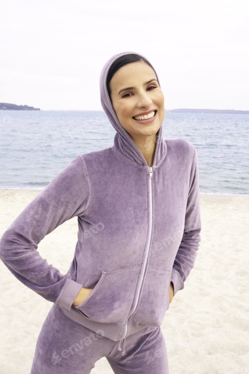 Preview: Portrait Of A Young Woman Standing On The Beach And Smiling