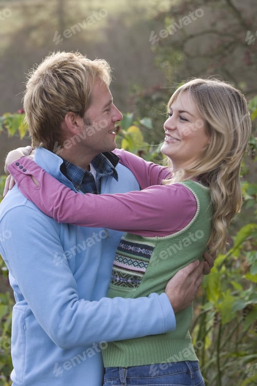 Preview: Smiling Couple Hugging Outdoors