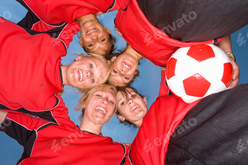 Preview: Smiling Teenage Girls In Soccer Team Uniforms In Huddle At Camera