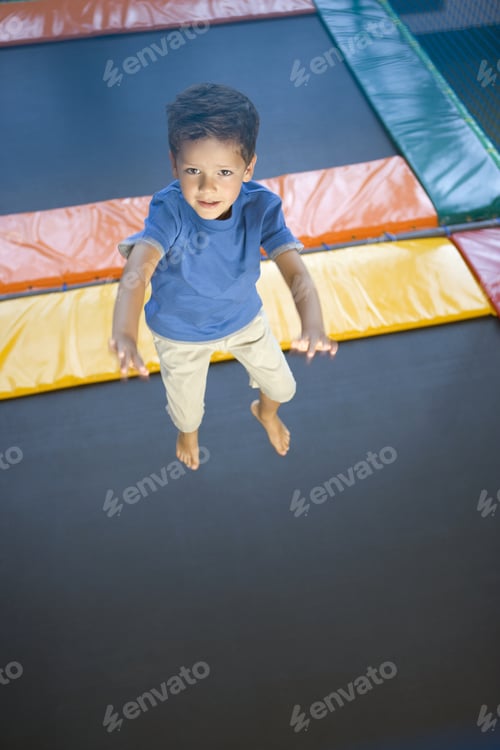 Preview: High Angle View Of A Boy Jumping On A Trampoline