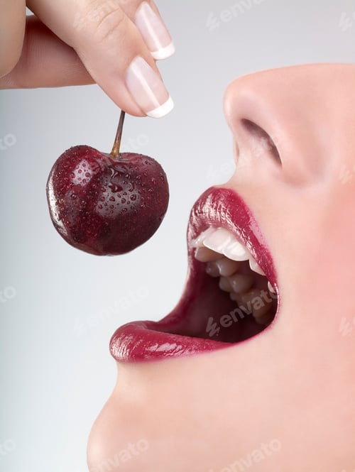 Preview: Studio Close Up Of Woman'S Mouth Eating Fresh Cherry