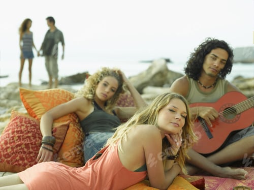 Preview: Side Profile Of A Young Woman Lying In Front Of A Young Couple