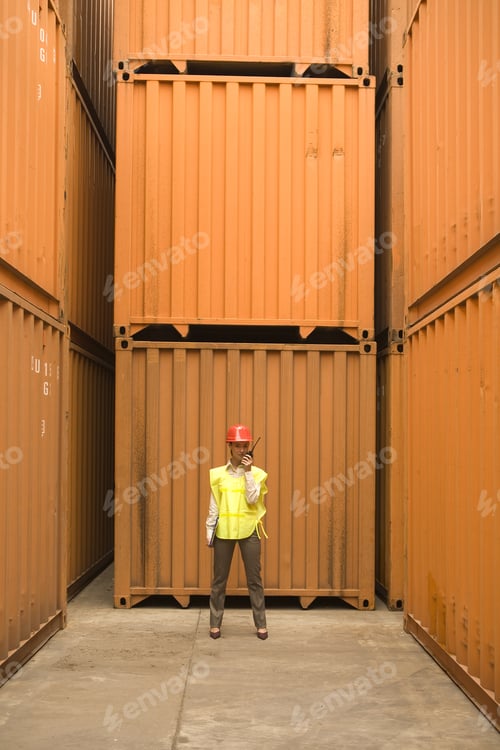 Preview: Female Dock Worker Talking On A Walkie-Talkie
