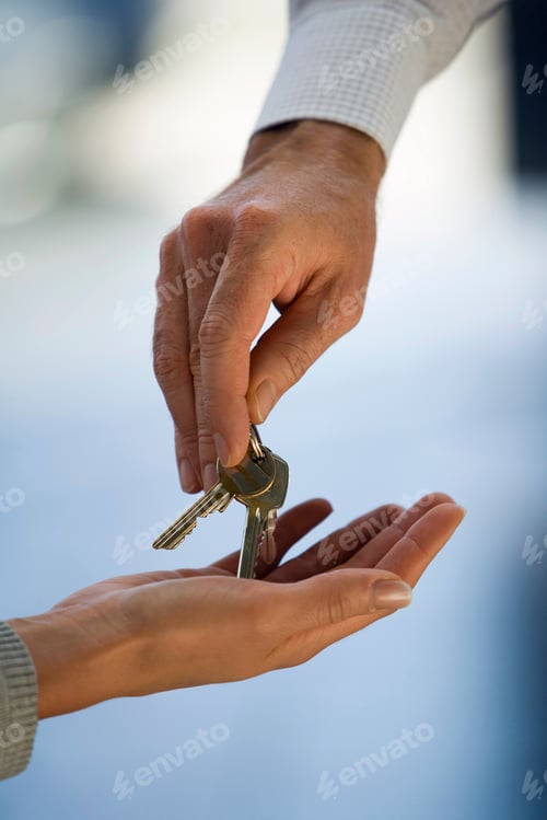 Preview: Detail Of Man Handing Woman Keys To New Home Or Car