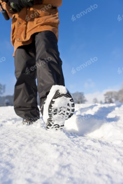 Preview: Close Up Of Woman'S Feet Walking Through Field Of Snow