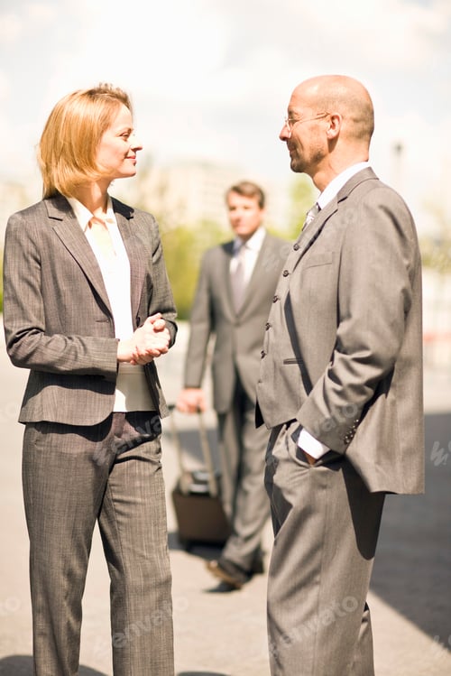 Preview: Businessman And Businesswoman Meeting Having Discussion In Street