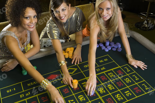 Preview: Woman And Friends Placing Gambling Chips On Roulette Table, Portrait, Elevated View