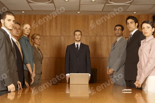 Preview: Group Of Business Executives Standing In A Board Room