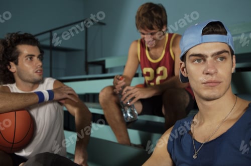 Preview: Three Young Men Sitting In A Basketball Court