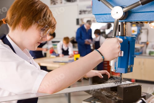 Preview: Female High School Student Using Drill In Metalwork Class