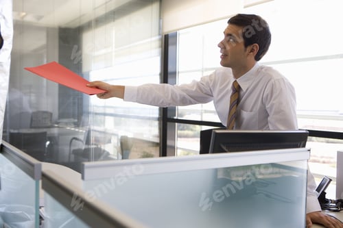 Preview: Businessman Holding Folder In Office