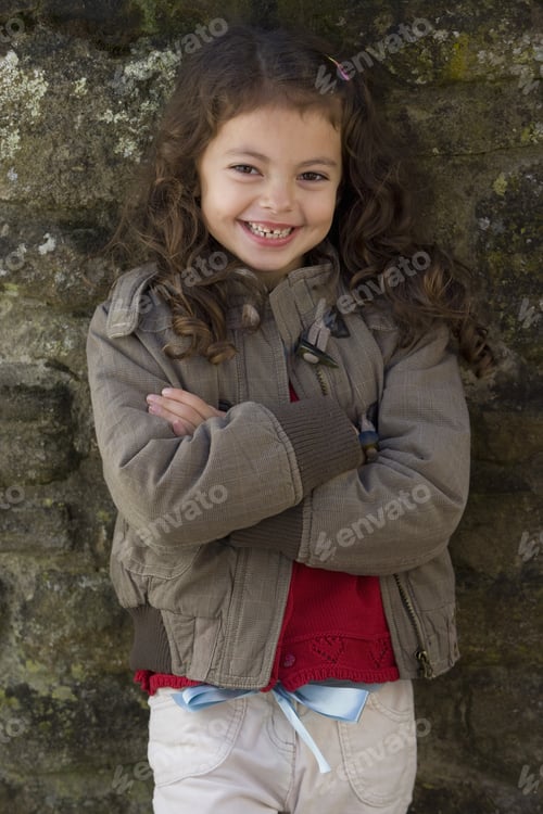 Preview: Smiling Girl With Arms Crossed Leaning Against Wall