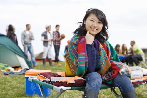 Preview: Young Woman Wrapped In Blanket Attending Outdoor Festival
