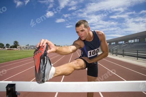 Preview: Male Athlete Stretching Hamstrings, Foot On Hurdle, Low Angle View