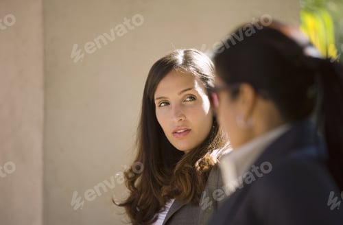 Preview: Two Businesswomen Having Meeting Outdoors, Side View (Differential Focus)