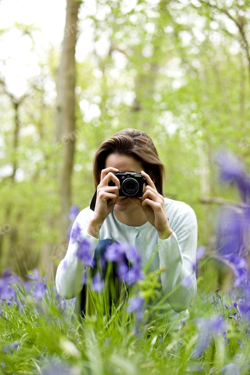 Preview: A Young Woman Photographing Bluebells, Smiling