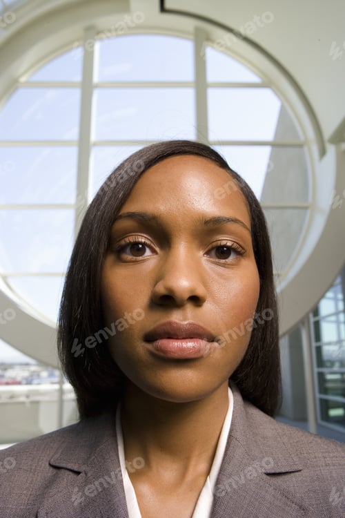 Preview: Businesswoman Standing In Front Of Round Window