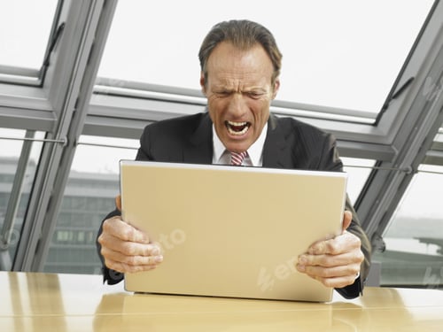 Preview: Businessman Holding His Laptop And Shouting