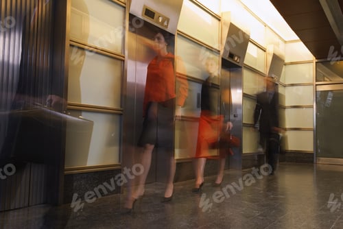 Preview: Motion Shot Of Businesspeople Walking Past Elevators