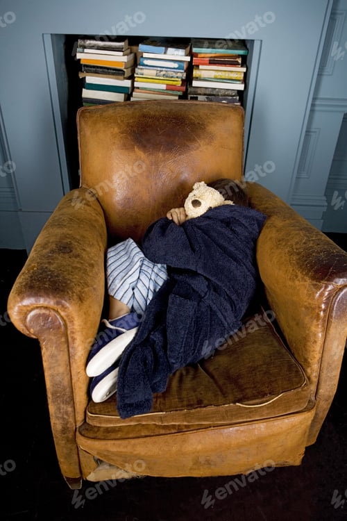 Preview: Little Boy Curled Up Asleep In Armchair
