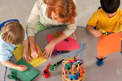 Preview: Woman Teaching And Helping Boys In Elementary School Art Class