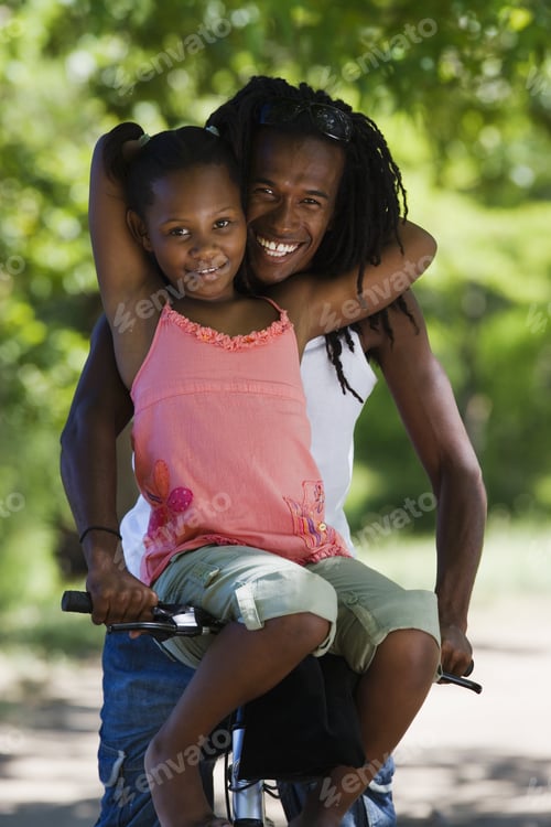 Preview: Father And Daughter Sitting On Mountain Bike, Girl Resting On Handlebars, Smiling, Portrait