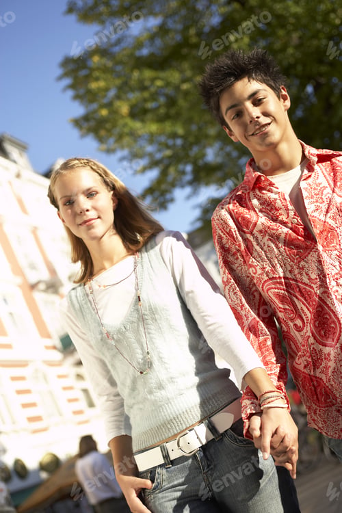 Preview: A Teenage Couple Walking Hand In Hand.