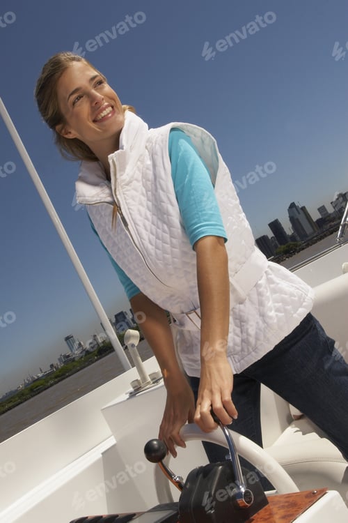 Preview: Young Happy Woman Steering Boat