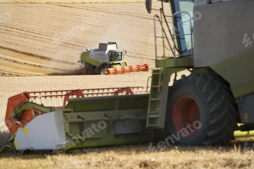Preview: Combines Harvesting Wheat In Sunny, Rural Field
