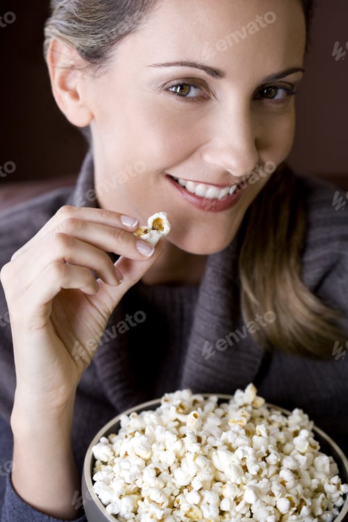 Preview: A Mid Adult Woman Eating Popcorn