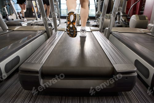 Preview: Legs Of Man Running On Treadmill In Health Club