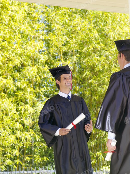Preview: Graduates Smiling At Each Other Outdoors