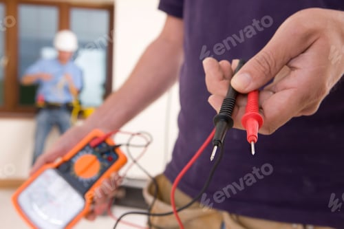 Preview: Detail Of Electrician Working In House Holding Voltage Meter