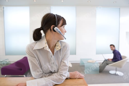 Preview: Businesswoman With Headset, Colleague In Background