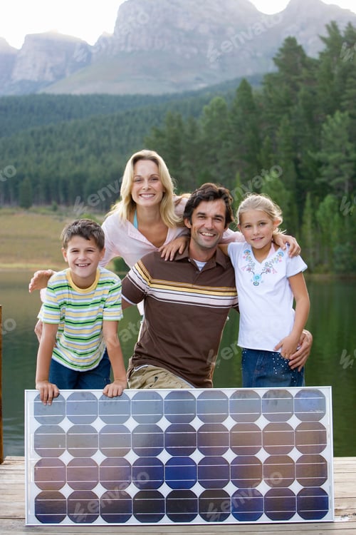 Preview: Family With Solar Panel On Jetty By Lake At Camera