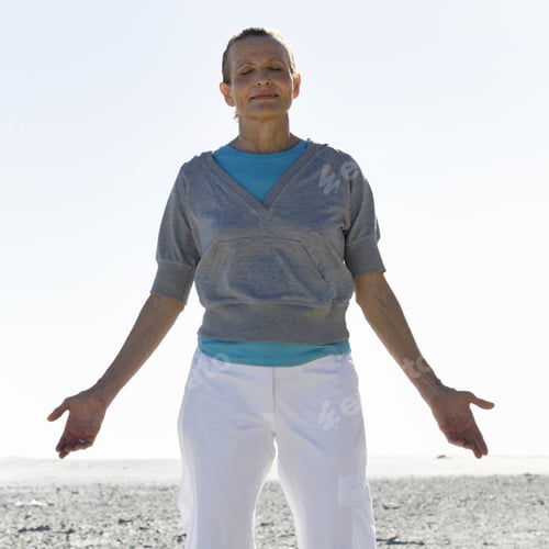 Preview: A Mature Woman Meditating On A Beach