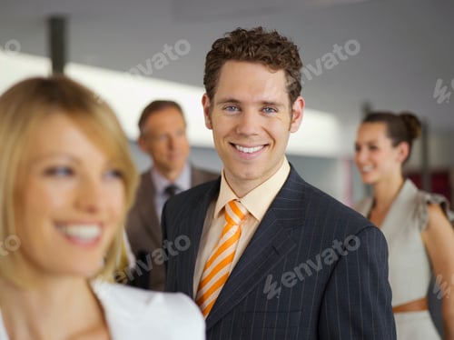 Preview: Portrait Of Smiling Businessman In Office With Colleagues