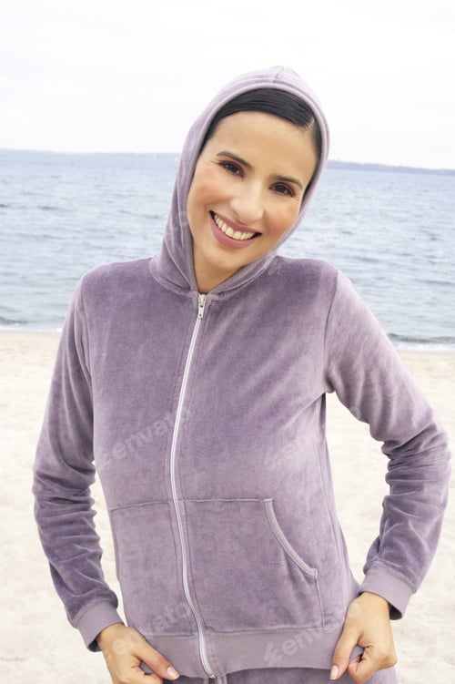 Preview: Portrait Of A Young Woman Standing On The Beach And Smiling