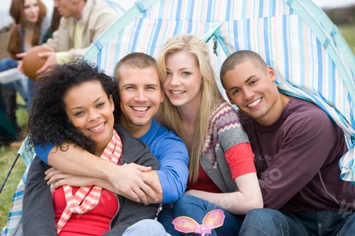 Preview: Group Of Young Friends Camping At Festival Inside Tent At Camera