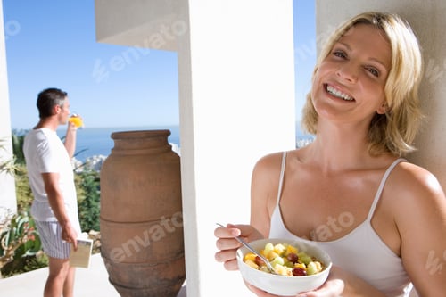 Preview: Woman Enjoying Fruit Salad on Balcony