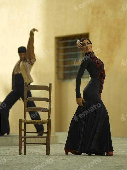Preview: Side Profile Of A Female Dancer Dancing With A Young Man In The Background