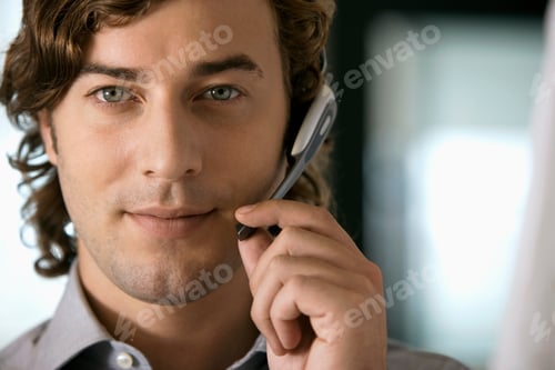 Preview: Portrait Of Businessman Wearing Office Telephone Headset For Communications