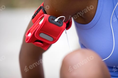 Preview: Close Up Of Active Female Jogger In Sportswear Wearing Mp3 Player In Red Case Attached To Arm
