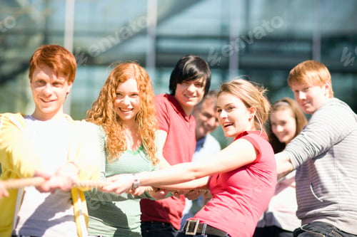 Preview: Group Of Teenagers In Tug Of War Match Pulling On Rope Outdoors