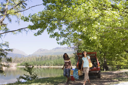 Preview: Couple Unloading Provisions From Parked Suv On Lakeside Camping Trip, Smiling